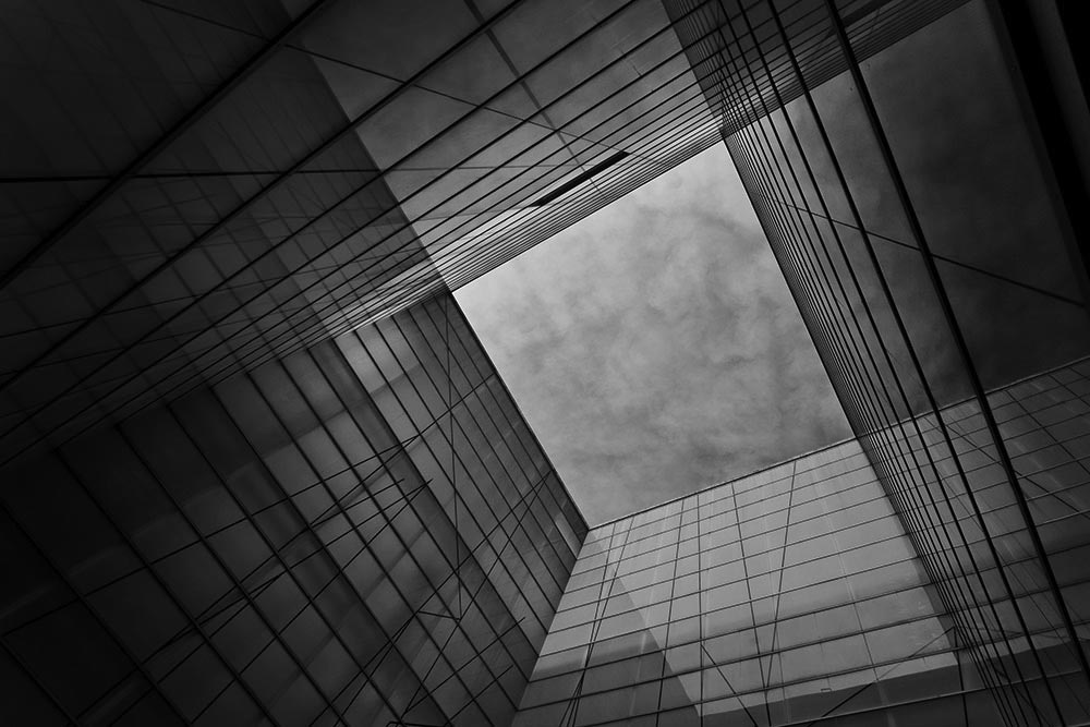 view of clouds looking up between four glass walls